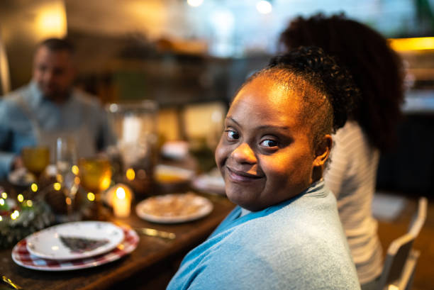 Portrait of a happy young woman with special needs during Christmas dinner at home